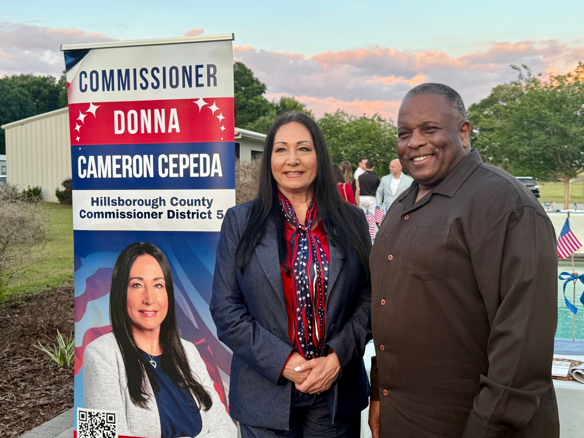 Donna standing with supporters beside a campaign sign in District 5